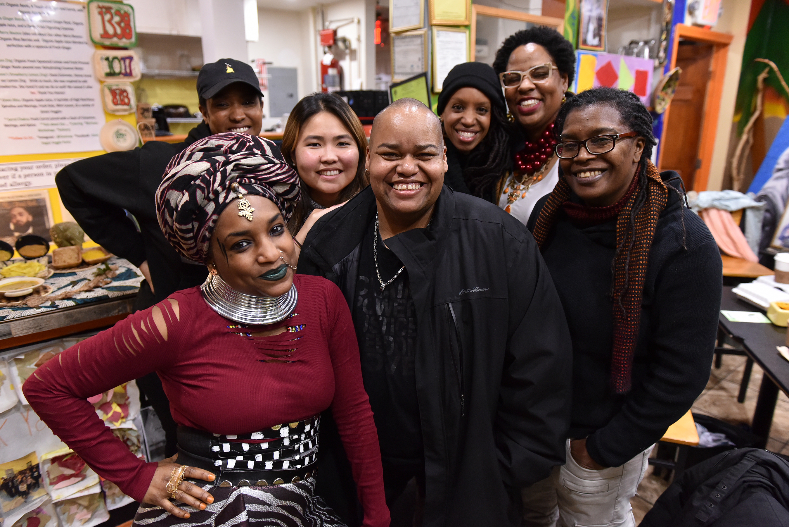 Boston artists (left to right) Nahdra Ra, Kendra Hicks, Ngoc-Tran Vu, Melissa Alexis, Latifa Ziyad and Letta Neely meet with Toshi Reagon (center) at Dorchester’s Oasis Vegan Veggie Parlor to discuss the Parable Path Boston.