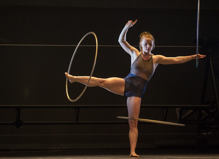 The 7 Fingers performer spinning hula hoops on her foot and leg