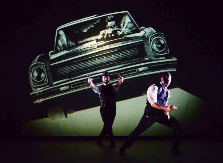 Two men running and pointing guns straight ahead with background of projected sketched car behind them in Plata Quemada