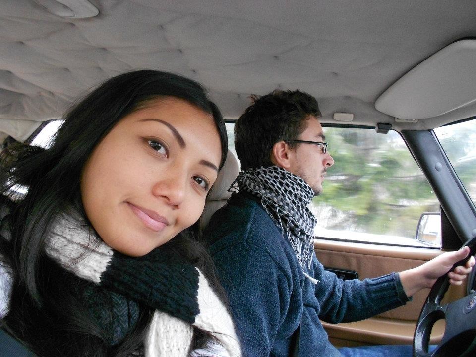 Smiling woman taking a selfie in the car while man is driving