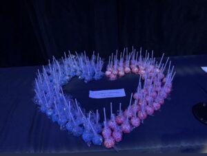 Red and blue cake pops placed in the shape of a heart