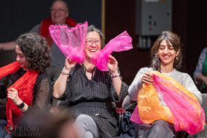 Audience member dressing herself in the scarf