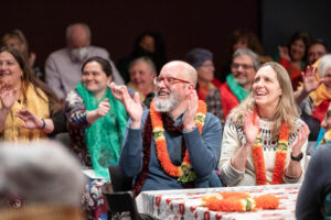 Audience members clapping along