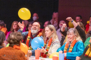 Audience members tossing balloons