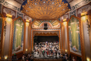 Wide view of Robert J Orchard stage with audience members on stage