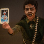 Puppet holding a tarot card