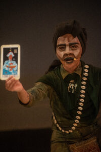 Puppet holding a tarot card