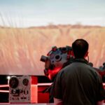 Person in front of wheat projection