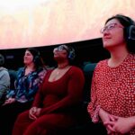 Audiences wearing headphones and enjoying the tech rehearsal