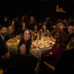 Attendees sitting at their banquet table