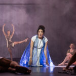 A cast member kneeling on the floor.