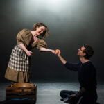 A woman giving an apple to a man.