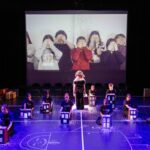 Children on stage covering their eyes