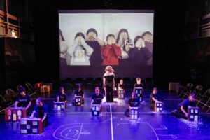 Children on stage covering their eyes