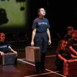 Child standing with a suitcase