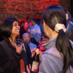 Audience members talking at the afterparty