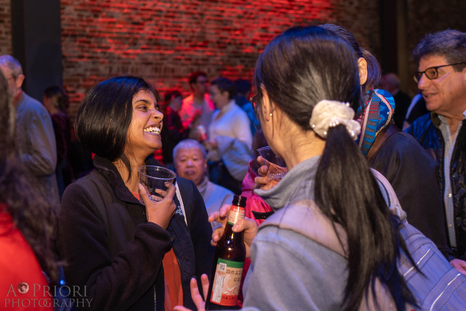 Audience members talking at the afterparty