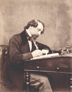 Photo of Charles Dickens writing