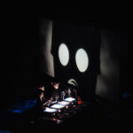 People doing shadow puppetry in front of the screen