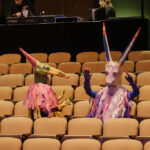 Life-sized puppets in the theater seats