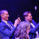 Patrons taking picture of the puppets at dinner