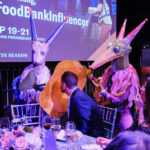 Life-sized puppets interacting with patrons at dinner