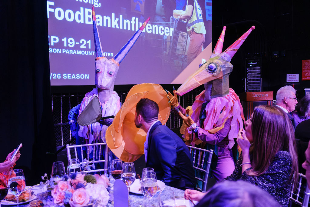 Life-sized puppets interacting with patrons at dinner