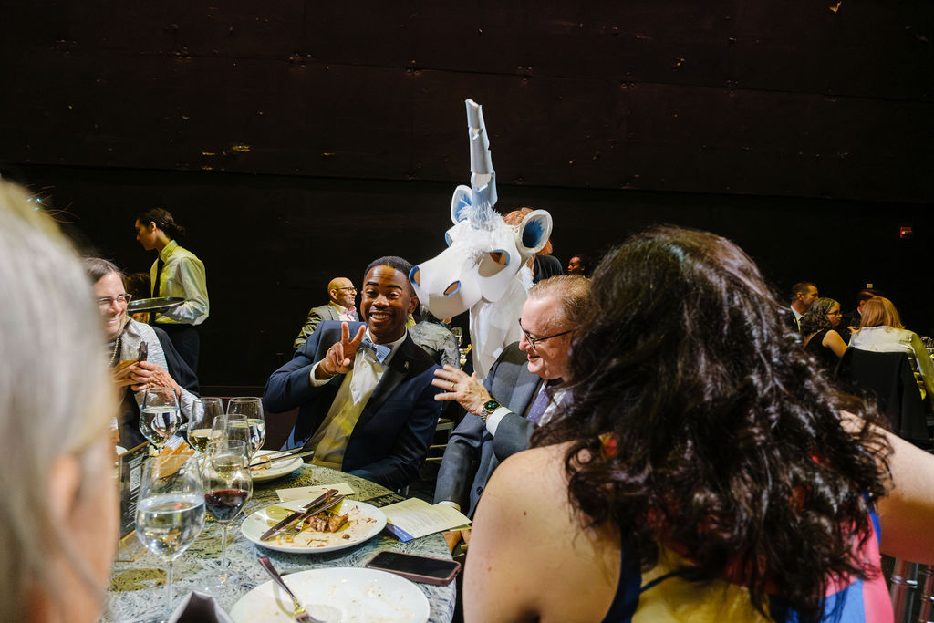 Life-sized puppets interacting with patrons at dinner