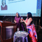 ArtsEmerson interim executive director Ronee Penoi giving award to World Alive! honoree