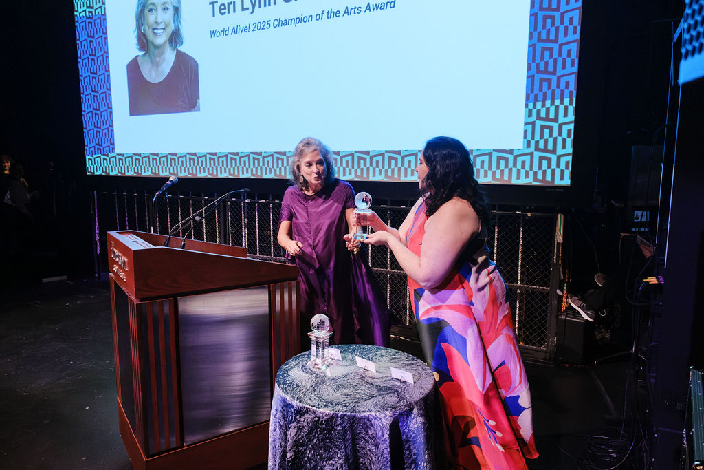 ArtsEmerson interim executive director Ronee Penoi giving award to World Alive! honoree