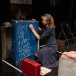 Woman writing on a blackboard